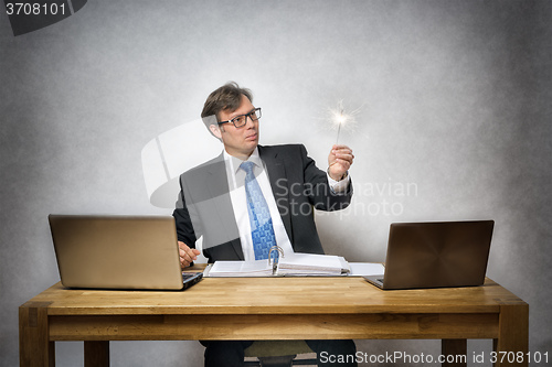 Image of business man with sparkler