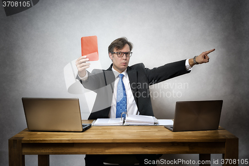 Image of Angry business man with red card