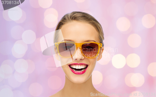 Image of happy young woman in sunglasses with pink lipstick