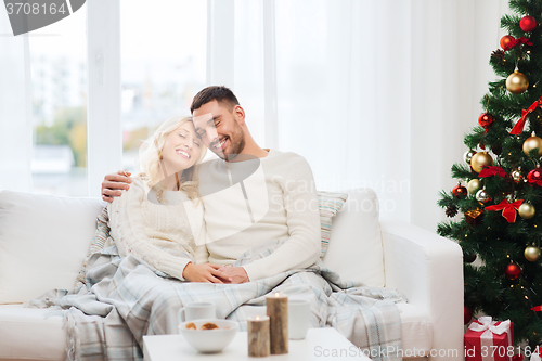 Image of happy couple at home with christmas tree