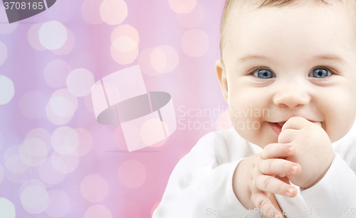 Image of happy baby over pink lights background