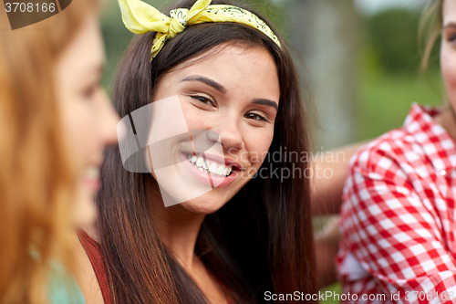 Image of happy young woman with group of friends outdoors