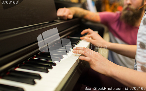 Image of close up of woman hands playing piano