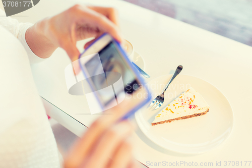 Image of woman hands with smartphone taking food picture