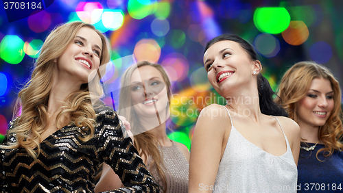 Image of happy young women dancing at night club disco