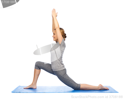 Image of happy woman making yoga in low lunge on mat