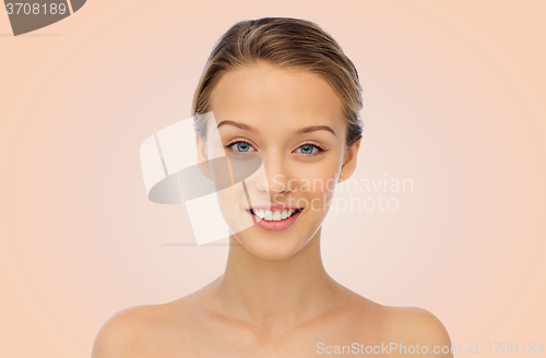 Image of smiling young woman face and shoulders