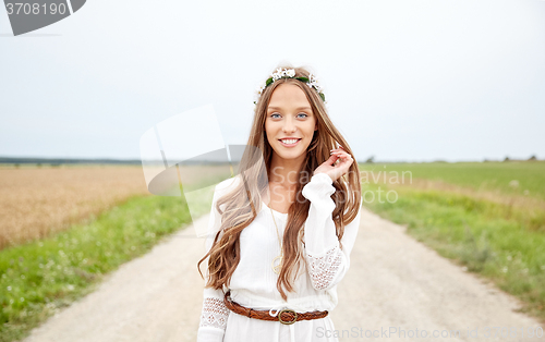 Image of smiling young hippie woman on cereal field