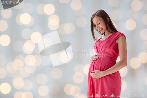 Image of happy pregnant woman with big tummy