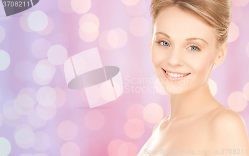 Image of lovely woman face over pink lights background