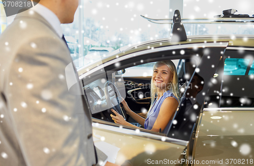 Image of happy woman with car dealer in auto show or salon