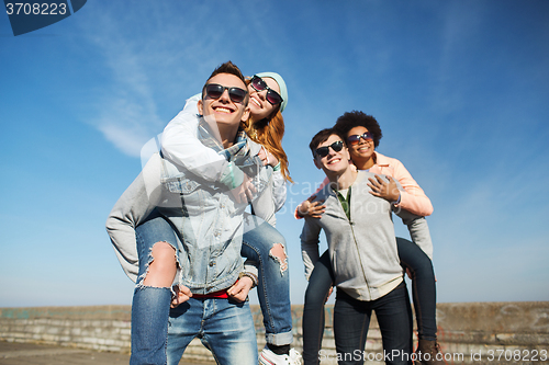 Image of happy friends in shades having fun outdoors