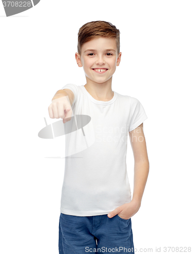 Image of happy boy in white t-shirt pointing finger to you