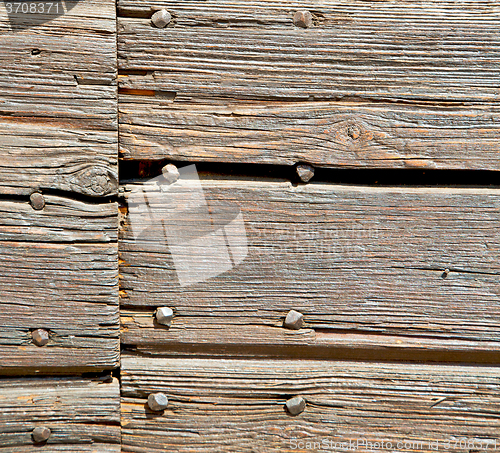 Image of abstract texture of a brown antique wooden old door in italy   e