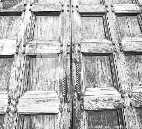 Image of abstract texture of a brown antique wooden old door in italy   e