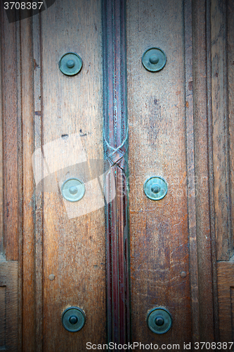 Image of in london antique brown door  rusty  brass nail and light