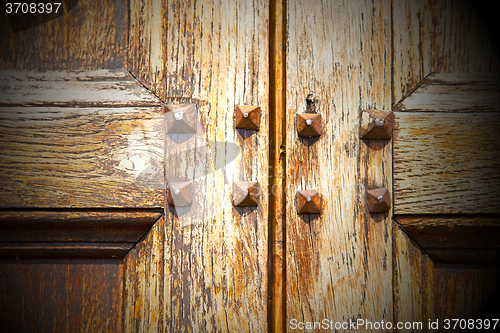 Image of abstract texture of a brown antique wooden old door in italy   e