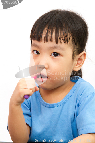 Image of Chinese little girl brushing teeth