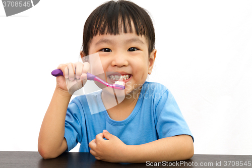 Image of Chinese little girl brushing teeth