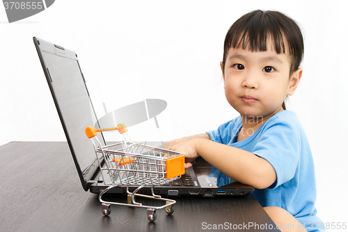 Image of Chinese little girl using laptop