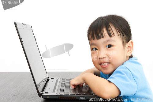 Image of Chinese little girl using laptop