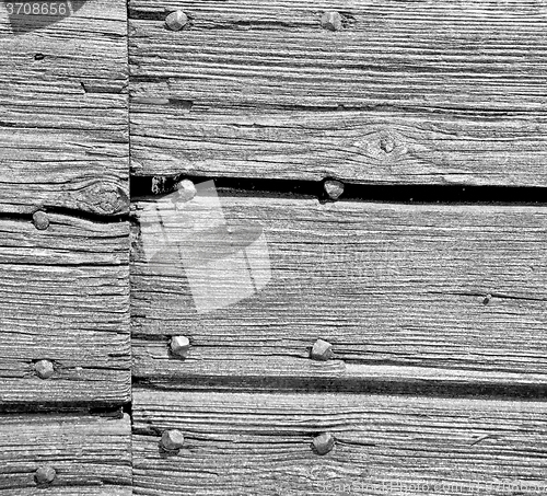 Image of abstract texture of a brown antique wooden old door in italy   e