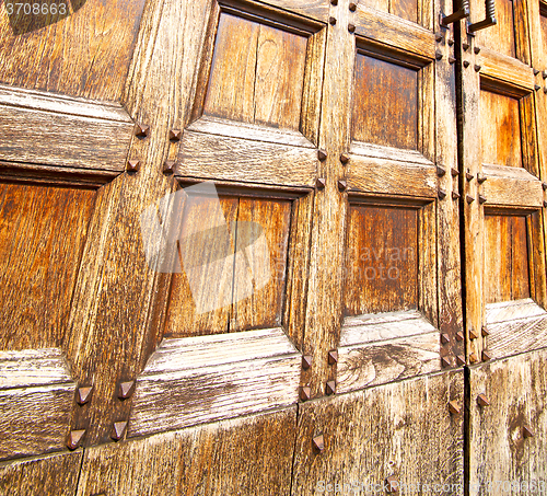 Image of abstract texture of a brown antique wooden old door in italy eur