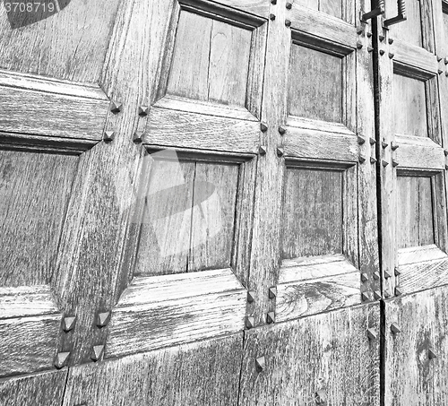 Image of abstract texture of a brown antique wooden old door in italy eur