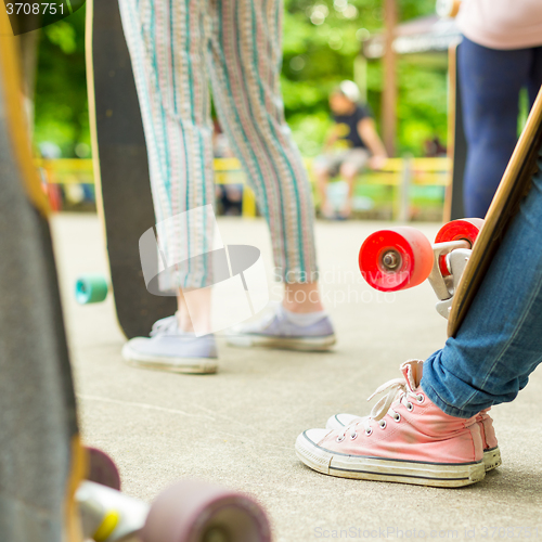 Image of Teenage girl practicing riding long board.