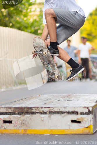 Image of Boys skateboarding on street. Urban life.