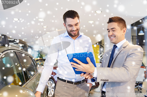 Image of happy man with car dealer in auto show or salon