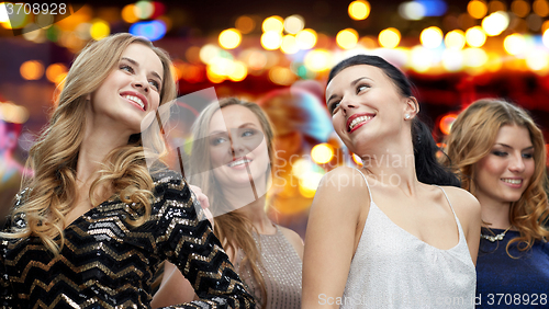 Image of happy young women dancing at night club disco