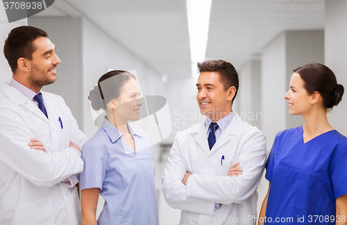 Image of happy group of medics or doctors at hospital