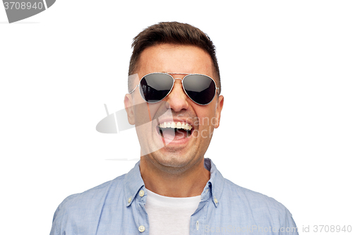 Image of face of smiling man in shirt and sunglasses