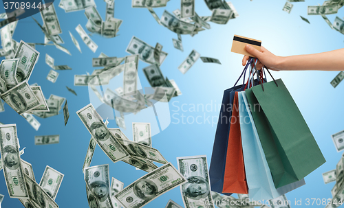 Image of close up of male hand shopping bags and bank card