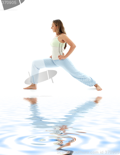 Image of virabhadrasana warrior pose on white sand