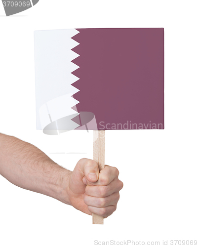 Image of Hand holding small card - Flag of Qatar