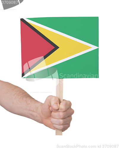 Image of Hand holding small card - Flag of Guyana