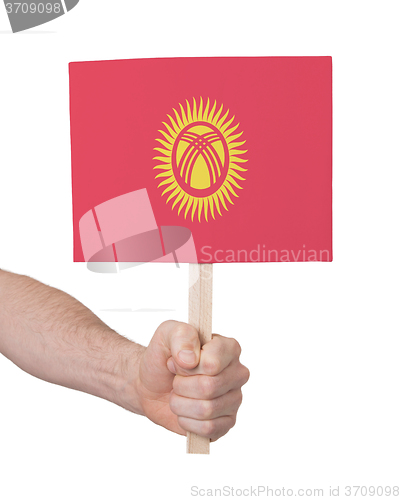 Image of Hand holding small card - Flag of Kyrgyzstan