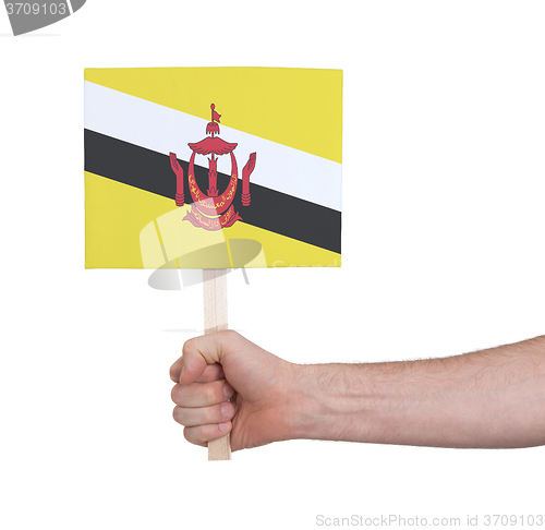 Image of Hand holding small card - Flag of Brunei