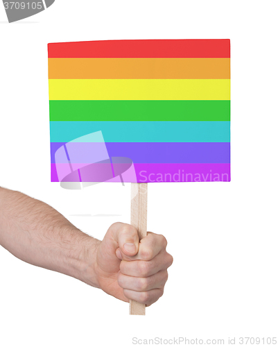 Image of Hand holding small card - Flag of Rainbow flag