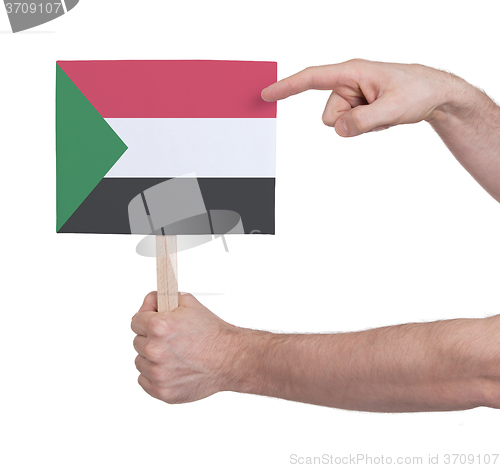 Image of Hand holding small card - Flag of Sudan