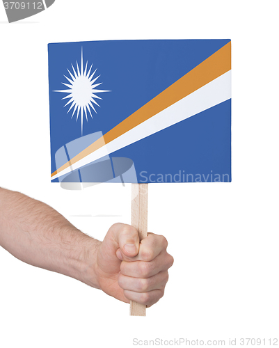 Image of Hand holding small card - Flag of Marshall Islands