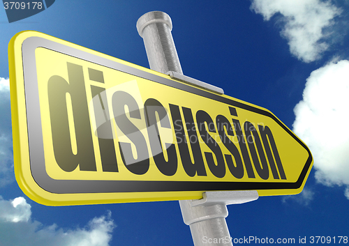 Image of Yellow road sign with discussion word under blue sky