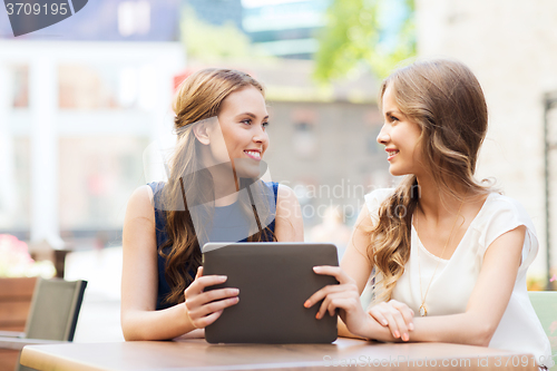 Image of happy young women or teenage girls with tablet pc