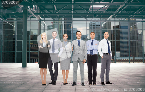 Image of group of smiling businesspeople over office room