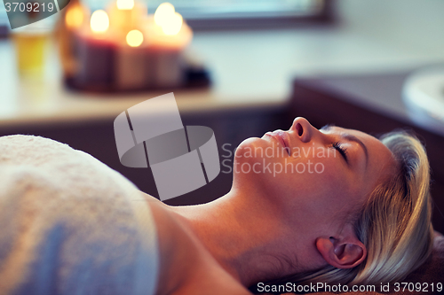 Image of young woman lying in spa