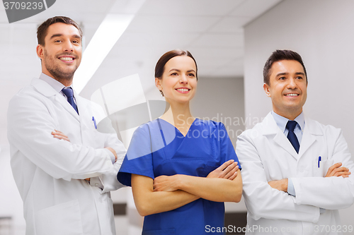 Image of happy group of medics or doctors at hospital
