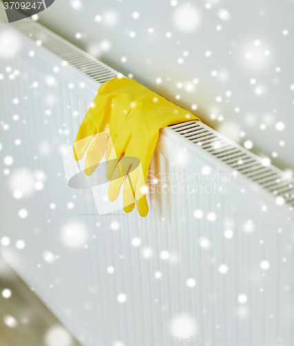 Image of close up of rubber gloves hanging on heater