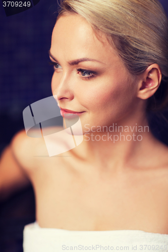 Image of close up of young woman sitting in bath towel